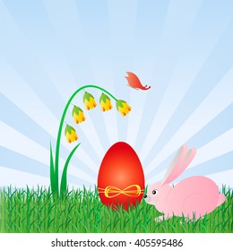 Pink rabbit near the red Easter egg in green grass on blue sky background.