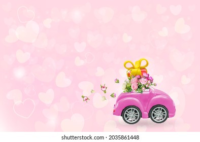 Pink retro car with gift box on a roof with flowers on pink background. Vector