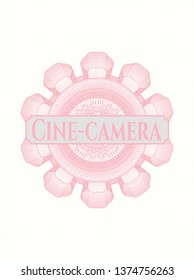 Pink rosette or money style emblem with text Cine-camera inside