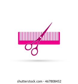 pink scissors and comb on white background.