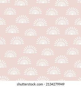 Pink seamless pattern with hand drawn suns and rainbows. Fabric design with rising sun or sunset.