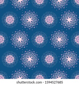 A pink snowflake mandalas seamless vector pattern on blue background. Boho christmas surface print design. Great for stationery, fabrics and packaging.