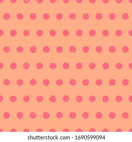 Pink textured polka dot background. Cute seamless pattern with pink circles on orange background. Hand drawn doodle style. Vector illustration.