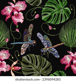 Pink tropical orchid flowers, palm leaves and colorful dragonflies. Floral jungle forest seamless pattern. Dark fashion template for clothes, textiles