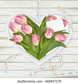 Pink tulips and heart frame on white wooden board. Top view. EPS 10 vector file included