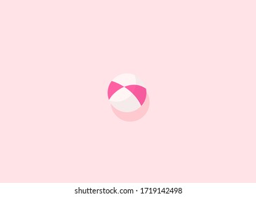 Pink white beach ball icon on a delicate pink background, top view, flat lay