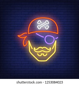 Pirate head in bandana and eye patch neon sign. Pirates, evil and warning design. Night bright neon sign, colorful billboard, light banner. Vector illustration in neon style.