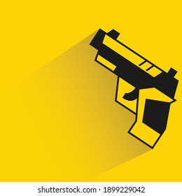 pistola con sombra de caída sobre fondo amarillo
