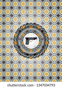 pistol icon inside arabesque emblem background. arabic decoration.