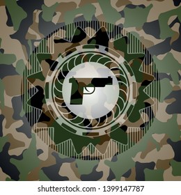 pistol icon inside camouflage texture