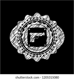 pistol icon inside chalk emblem written on a blackboard