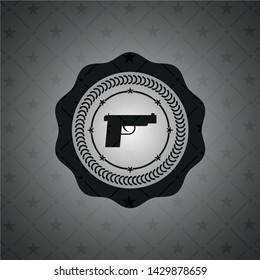 pistol icon inside dark emblem