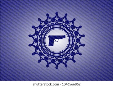 pistol icon inside emblem with denim high quality background
