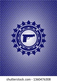 pistol icon inside emblem with denim high quality background