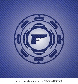 pistol icon inside emblem with denim high quality background