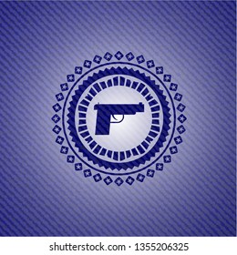 pistol icon inside emblem with jean background