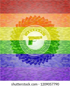 pistol icon inside emblem on mosaic background with the colors of the LGBT flag
