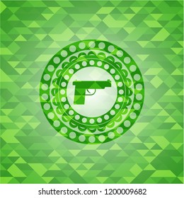 pistol icon inside green emblem with mosaic ecological style background