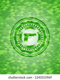 pistol icon inside green emblem. Mosaic background