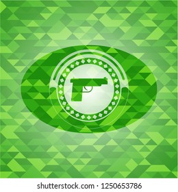 pistol icon inside green emblem with mosaic ecological style background