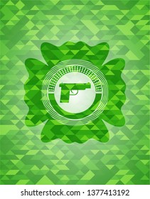 pistol icon inside green emblem with mosaic background