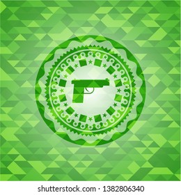 pistol icon inside green emblem. Mosaic background