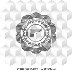 pistol icon inside grey badge with geometric cube white background