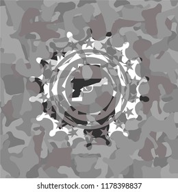 pistol icon inside grey camo emblem