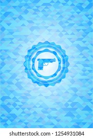 pistol icon inside light blue emblem with triangle mosaic background