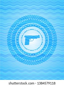 pistol icon inside light blue water badge background.