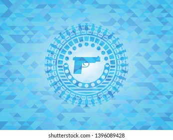 pistol icon inside light blue mosaic emblem