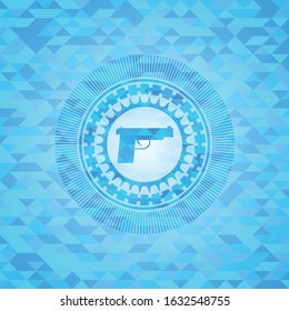 pistol icon inside light blue mosaic emblem