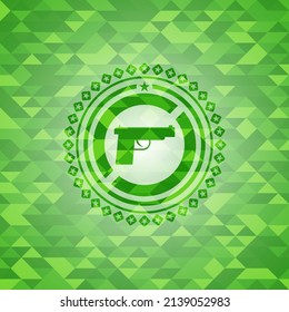 pistol icon inside realistic green mosaic emblem. 