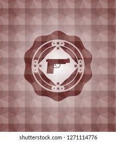 pistol icon inside red seamless badge with geometric pattern.