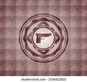 pistol icon inside red seamless emblem or badge with abstract geometric polygonal pattern background.