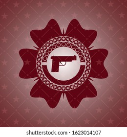 pistol icon inside retro red emblem