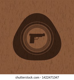 pistol icon inside retro style wood emblem