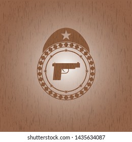 pistol icon inside retro style wooden emblem