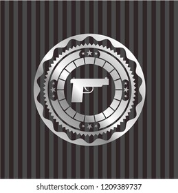 pistol icon inside silver badge