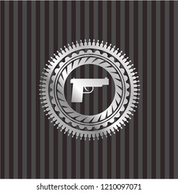 pistol icon inside silver emblem