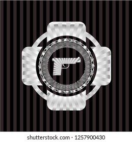 pistol icon inside silver emblem