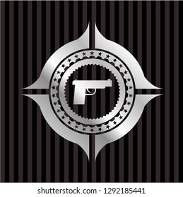 pistol icon inside silver emblem or badge