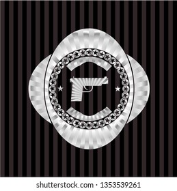 pistol icon inside silver emblem