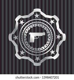 pistol icon inside silvery emblem or badge