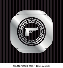 pistol icon inside silvery shiny badge