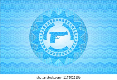pistol icon inside sky blue water style emblem.