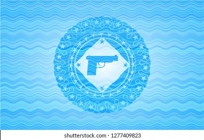 pistol icon inside sky blue water style badge.