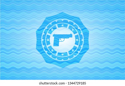 pistol icon inside water wave emblem.