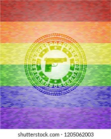 pistol icon on mosaic background with the colors of the LGBT flag