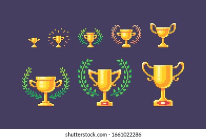 Pixel art set of gold winner cups different forms and sizes. Vector illustration.